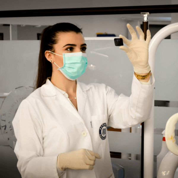 A female scientist looking at a microscope slide in a lab.