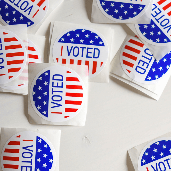 Ten "I Voted" stickers scattered across a white surface.