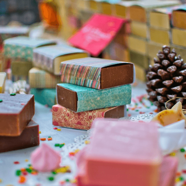 A stack of 3 chocolate bars wrapped in colorful paper.