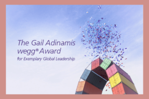 Gail Adinamis Award The text "The Gail Adinamis wegg® Award for exemplary global leadership" is written across a blue sky background with multi-colored confetti around it.