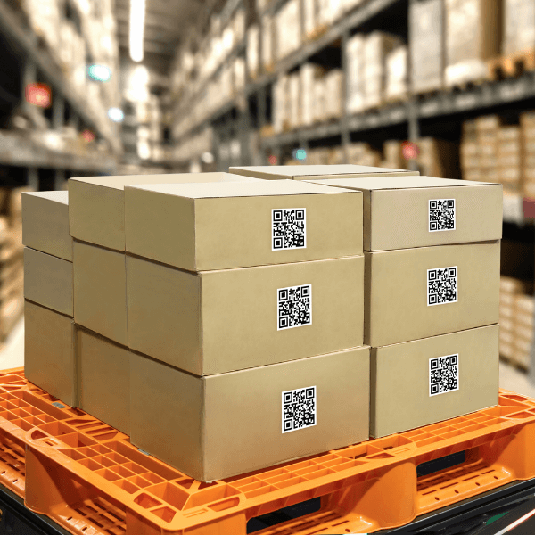 A stack of shipping boxes on top of a dock in a warehouse.