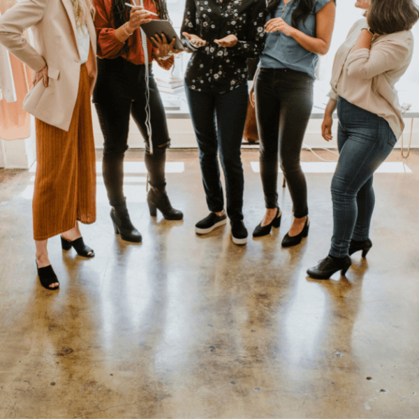 A group of women standing in a sermi-circle facing each other.