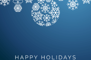 A blue background with white ornaments hanging. They are made out of snowflakes and the text 'Happy Holidays' is written across the blue background.