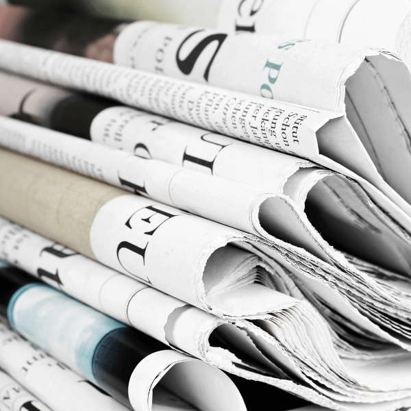 A stack of folded newspapers.